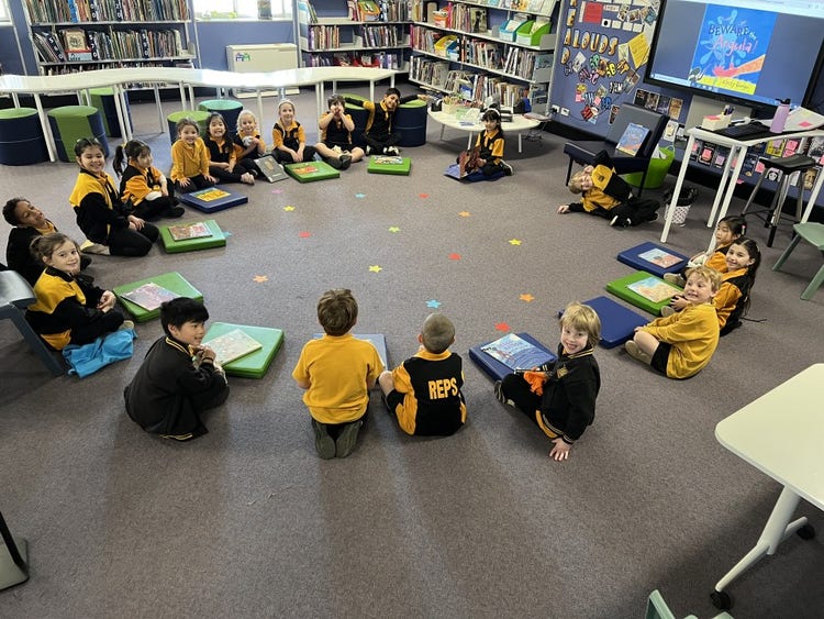 Students seated in a learning circle during a library lesson.