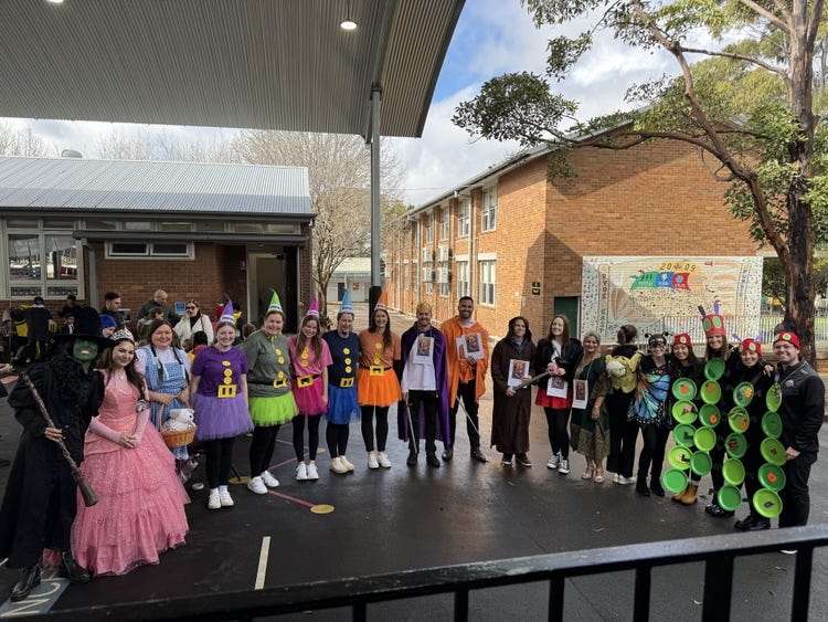 Whole school staff celebrating Book Week together outdoors, dressed in creative costumes following the parade.